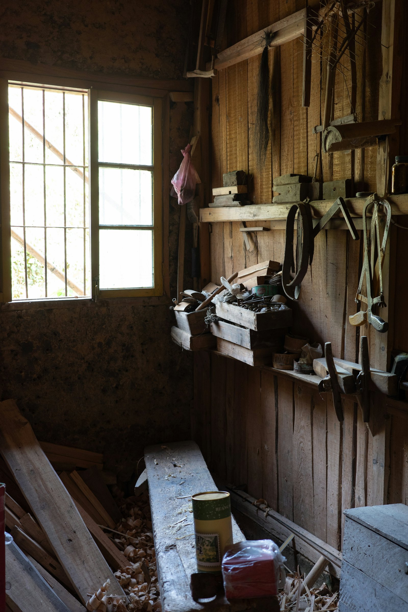 A timber workshop with hand tools, a bench and wood shavings